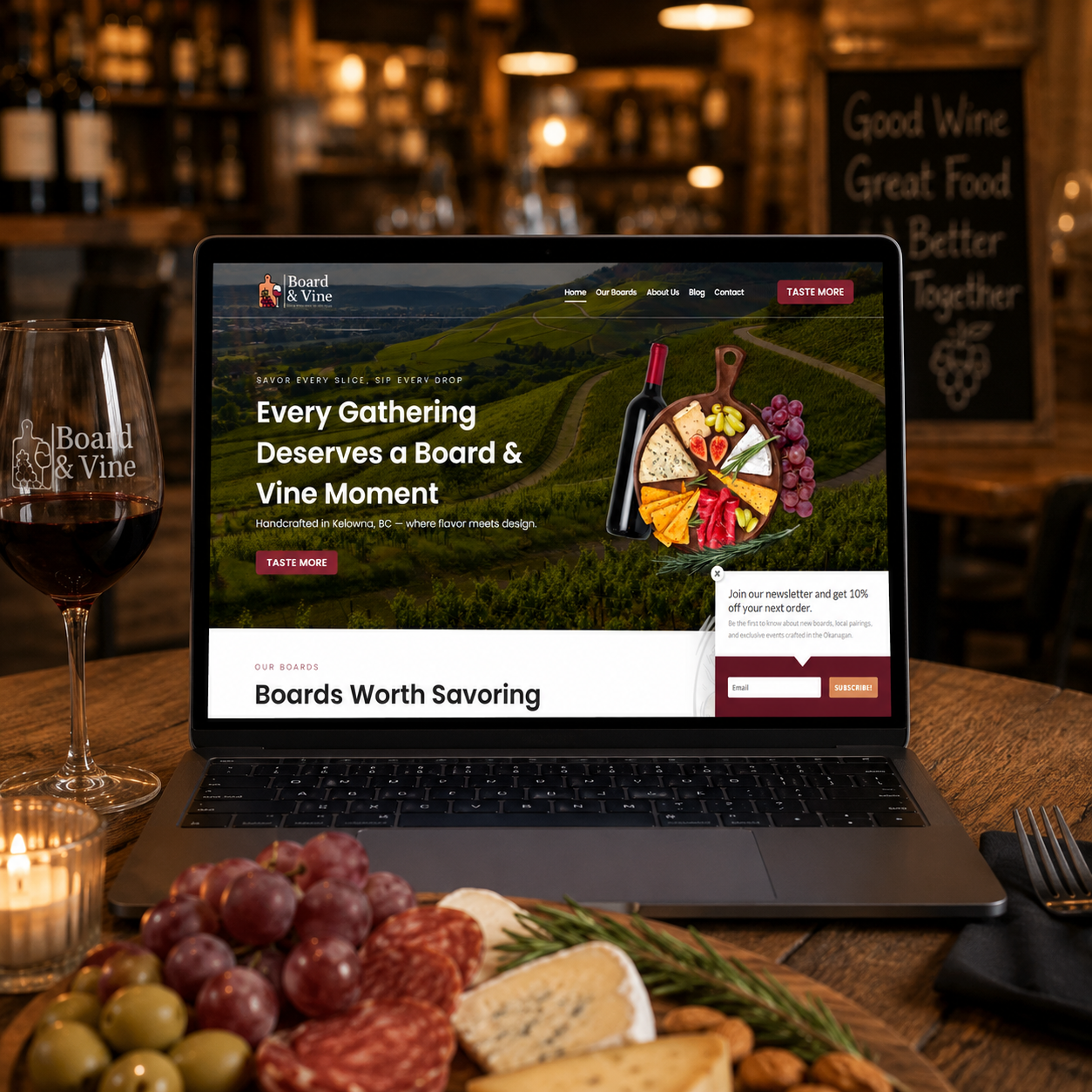 Board & Vine Website Design & Branding Project Board & Vine website displayed on a laptop in a cozy restaurant setting with wine, charcuterie, and warm ambient lighting.